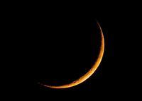 Moon sliced at sunset